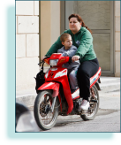 Woman & child on motor bike, Crete, Greece